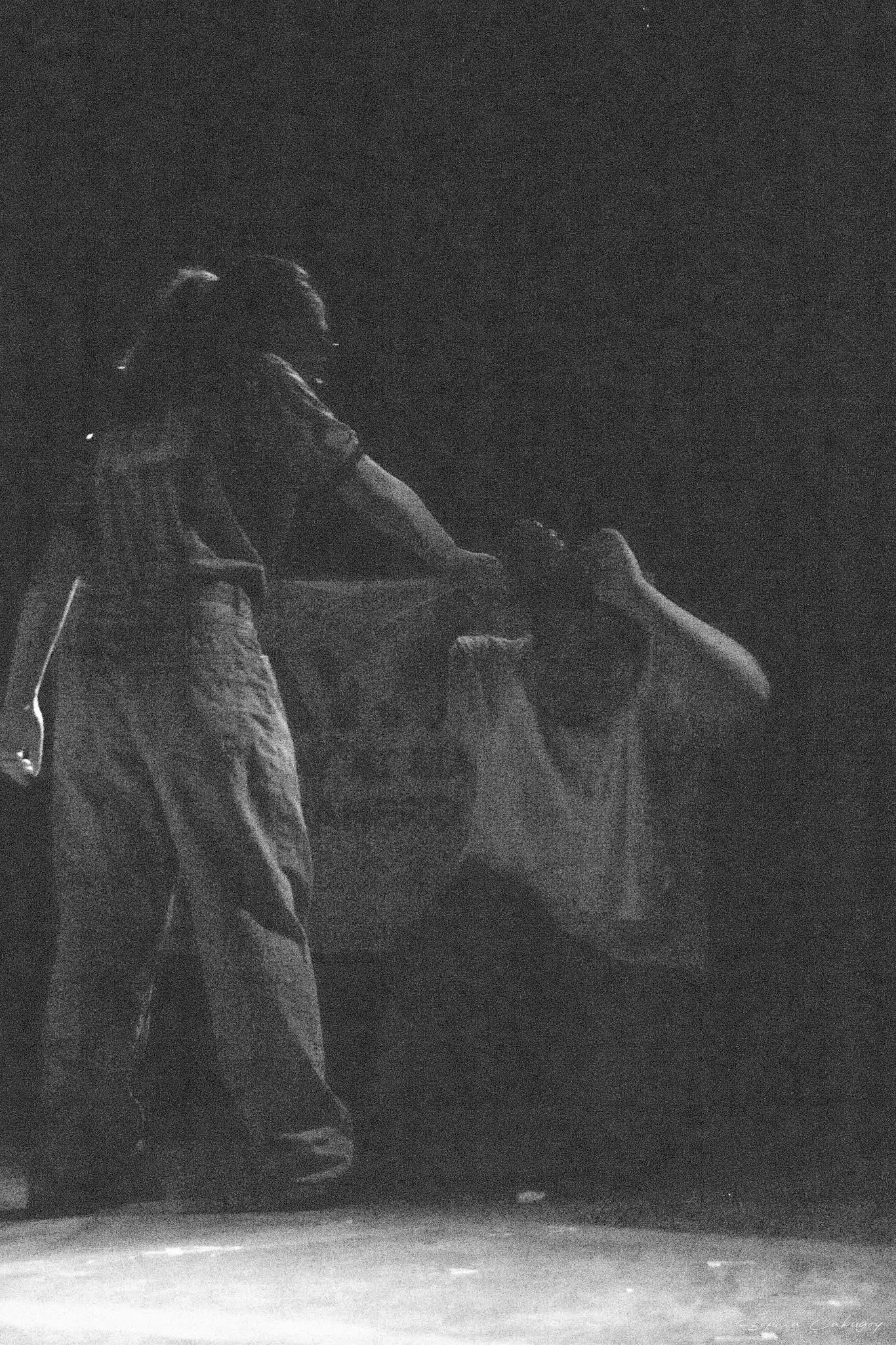 Black-and-white performance scene from Ang Report